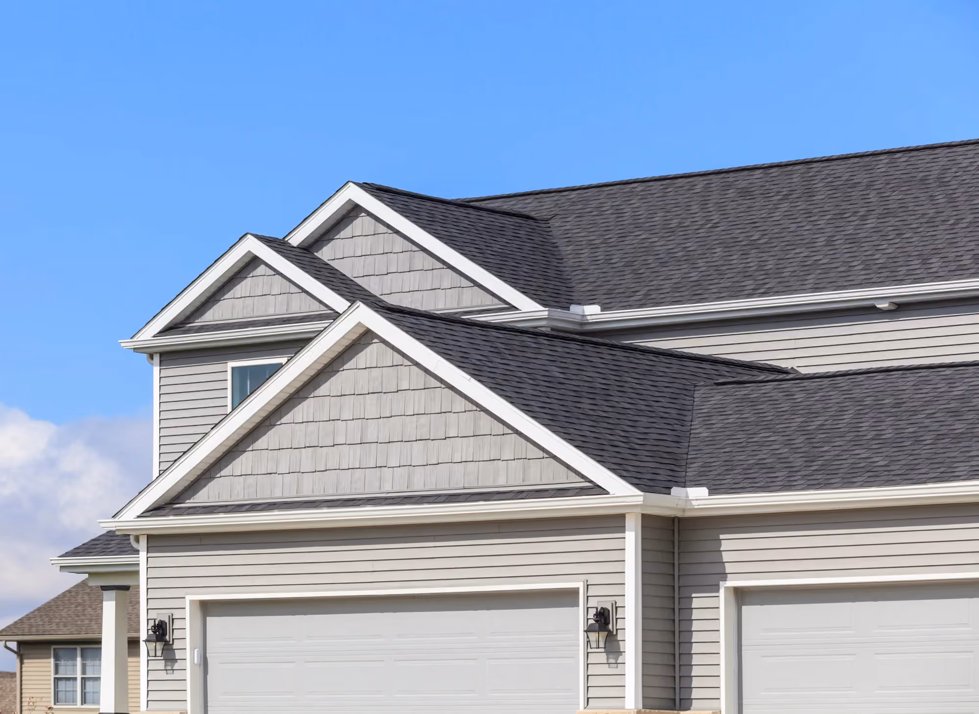 Roofline and siding on a central Kentucky home, shingles meeting the soffit at the eave