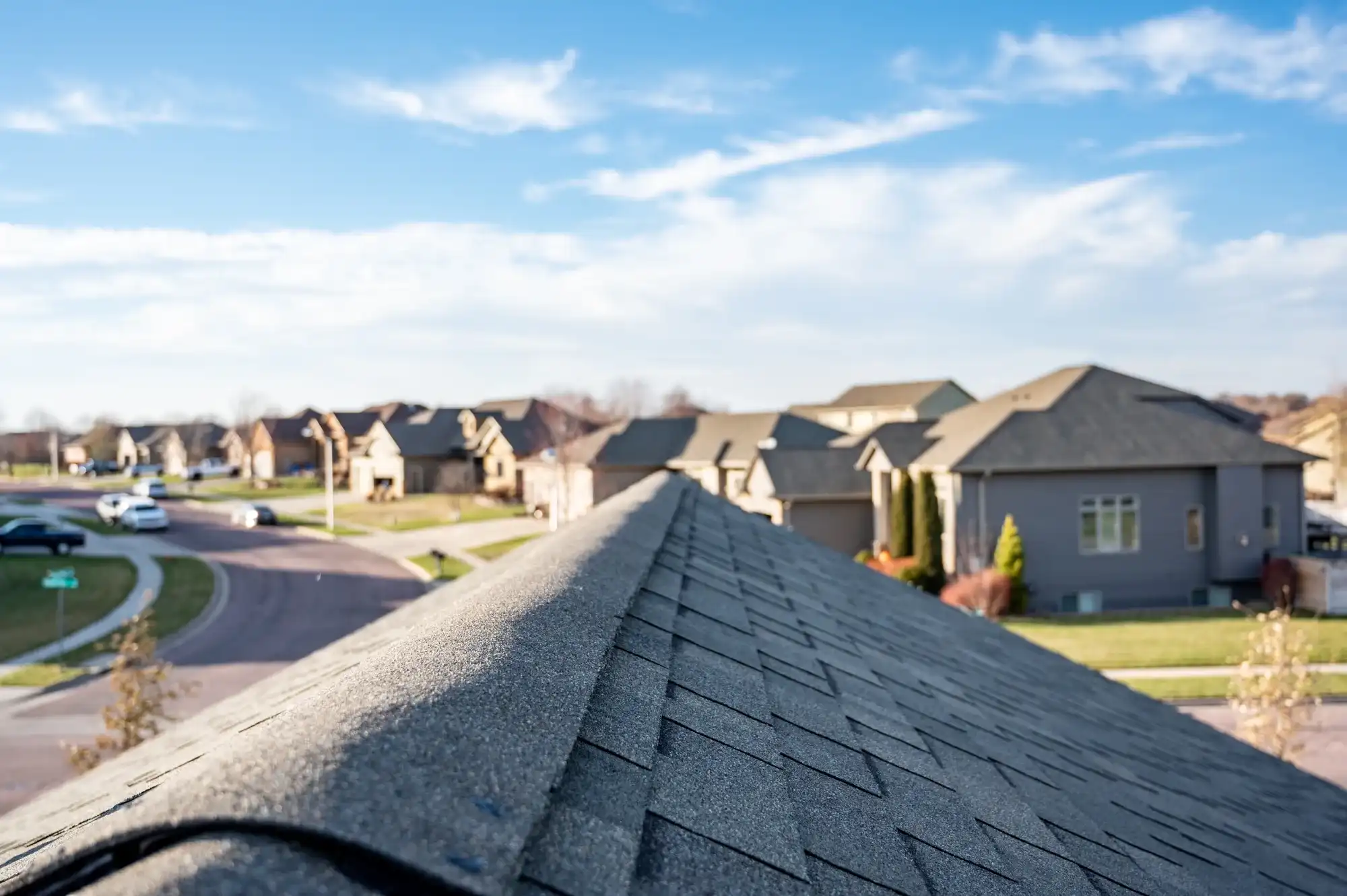 New asphalt shingles being installed on a pitched residential roof