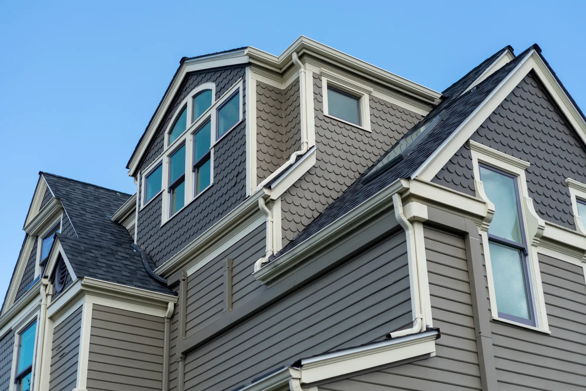 hail-dented or cracked vinyl siding after storm, photographed during an inspection